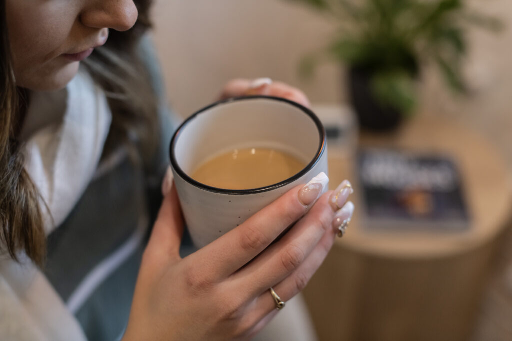 Woman holding a warm cup of tea during a relaxing stay at Kaiser Ridge eco stay